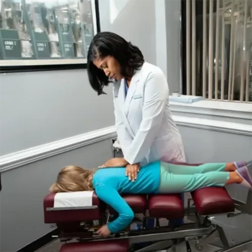 Dr. Darlene Sauls-Bassfield, a chiropractor at Chiropractic Family Healthcare, with a patient